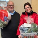 SPD chaplain and Light A Lamp founder holding healing baskets